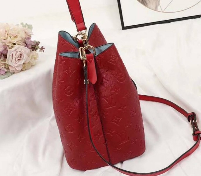 Louis Vuitton Monogram Empreinte NeoNoe MM Bag In Red angle 4