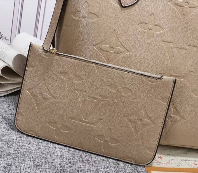 Louis Vuitton Monogram Empreinte Neverfull MM Tote In Beige angle 3