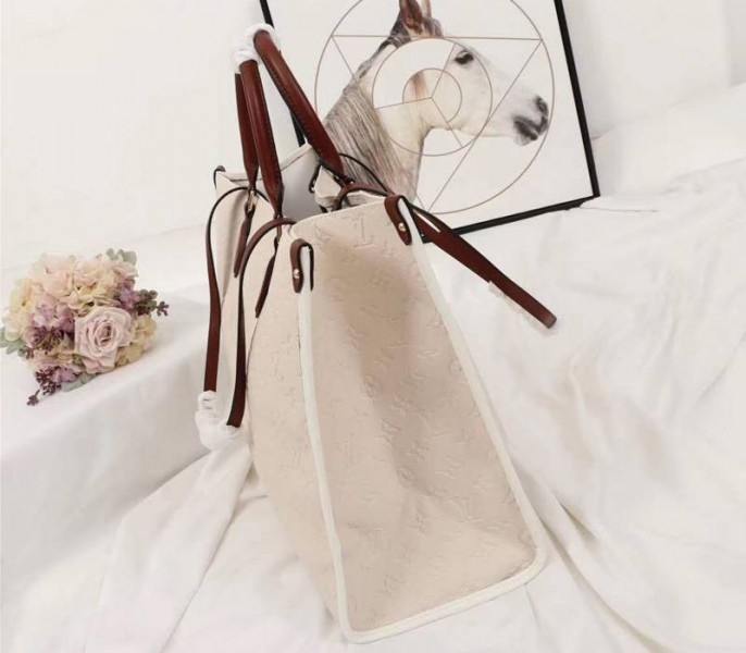 Louis Vuitton Monogram Empreinte Onthego GM Tote In Cream angle 3