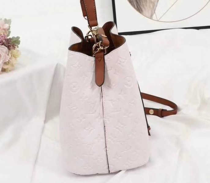Louis Vuitton Monogram Empreinte NeoNoe MM Bag In Cream angle 4
