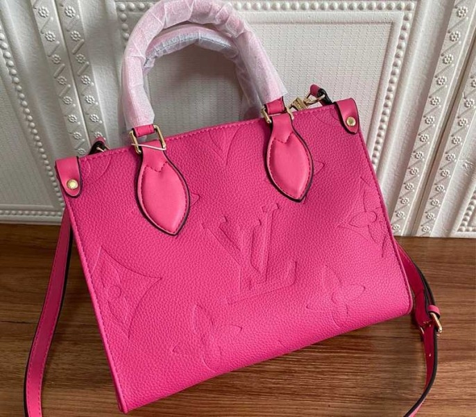 Louis Vuitton Monogram Empreinte Leather Onthego PM Bag In Freesia Pink angle 2