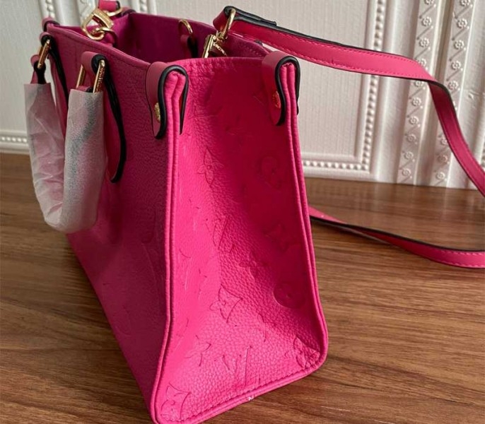 Louis Vuitton Monogram Empreinte Leather Onthego PM Bag In Freesia Pink angle 5